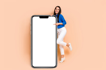 Poster - Photo of positive stunning lady wear blue stylish clothes arm demonstrate empty blank space website isolated on beige color background