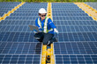 © Washburn - Technician Adjusting Solar Panel at Installation Site
