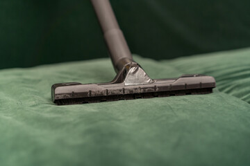 close-up of saw brush the process of cleaning a green velor sofa home furnishings cleaning cleanliness