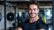 Fit brunette man. Portrait of a grinning man in gym attire, illustrating fitness and well-being.