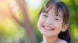 Joyful Asian girl with healthy teeth and metal braces, emphasizing pediatric dentistry concept.