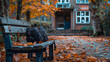 A school bag placed on a bench in a tranquil school courtyard, surrounded by autumn leaves.