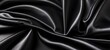 Smooth elegant black silk or satin texture can use as abstract background. 