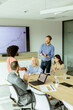 © BGStock72 - Diverse team engaging in collaborative efforts during a creative office meeting at midday