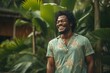 Portrait of a grinning afro-american man in his 30s donning a trendy cropped top in front of lush tropical rainforest