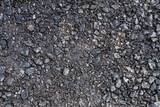 Fototapeta  - Świeżo zagęszczona pierwsza warstwa asfaltu. Wylewanie podstawowej pierwszej warstwy asfaltu na budowie nowej drogi.