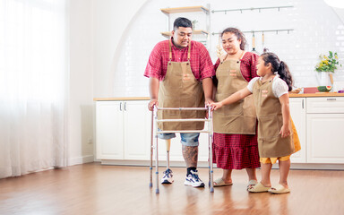 Wall Mural - Asian warm happy family helping, assisting father or husband with disable prosthetic leg practicing walking by walker in indoor cozy home, taking care with love, happiness. Healthcare Concept.