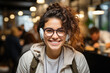 Happy young woman in glasses headphones sitting in cafe