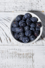 Wall Mural - fresh blueberries in a white bowl, vertical