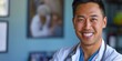 © HealthyStock - Beaming Asian male doctor in white coat outdoors with natural greenery in the background.