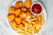 Chicken nuggets and french fries from above fast food meal eating snack with ketchup