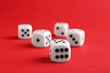 © New Africa - Many white game dices on red background, closeup