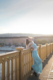 Fototapeta Miasta - young woman on a bridge in Budapest