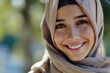 a joyful and positive Muslim woman in a hijab, embodying modesty and grace, typical for Arab women