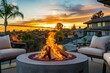 Outdoor modern fire pit in backyard with gray modern outdoor furniture, chairs, on the terrace of a residential building at sunset concept of relaxation rest and communication