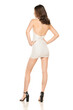 Summer Chic: Full-Length Portrait of a Young Woman Posing in a Short White Dress and Sandals on White Background. Back, Rear view