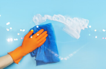 Wall Mural - Cleaning woman wiping with rag blue background .