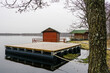 A new empty wooden platform on pontoons in the lake for the creation of a holiday house on the water