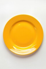 Poster - A simple yellow plate on a white surface. Suitable for kitchen or food-related designs