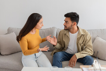 Couple having a conversation on the sofa