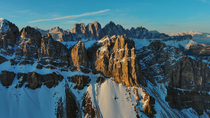 Wall Mural - Rocky snow mountains at sunrise aerial