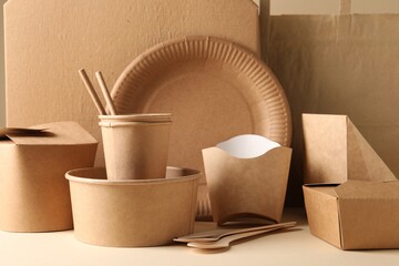 Wall Mural - Eco friendly food packaging. Paper containers, tableware and bag on white table