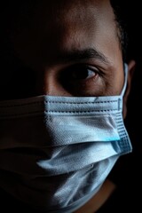 Poster - Close up of a person wearing a face mask, suitable for health and safety concepts