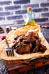 Wall Mural - fried liver on paper and on a wooden board