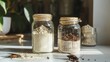 Two glass jars filled with fine insect flour, accompanied by whole edible insects, present a sustainable baking ingredient option on a kitchen countertop. Insect Flour in Glass Jars