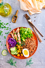 Wall Mural - Boiled buckwheat or porridge with chicken for breakfast, cooked salted eggs, vegetables and fresh greens