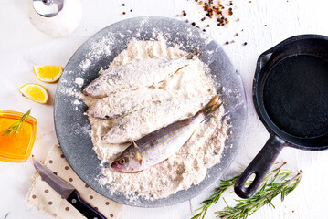 Canvas Print - Fillet fish coated in flour. Home cooked fish fillet.