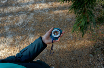 Compass in a kid hand with sea waveson background