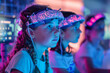 Children fascinated by a neon-lit educational brainwave headset