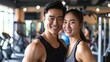 Smiling Asian Couple Poses for Camera in Gym
