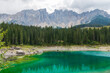 Blue lake in Dolomite Moutains, Italy, Carezza lake Lago di Carezza, Karersee with Mount Latemar, Bolzano South Tyrol, Italy.