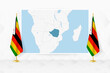 Map of Zimbabwe and flags of Zimbabwe on flag stand.