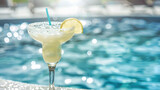 Fototapeta  - refreshing margarita alcoholic drink at the edge of a pool on a summer day