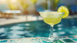 refreshing margarita alcoholic drink at the edge of a pool on a summer dayMelting ice popsicle: concept of summer is approaching