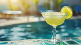 Fototapeta  - refreshing margarita alcoholic drink at the edge of a pool on a summer dayMelting ice popsicle: concept of summer is approaching