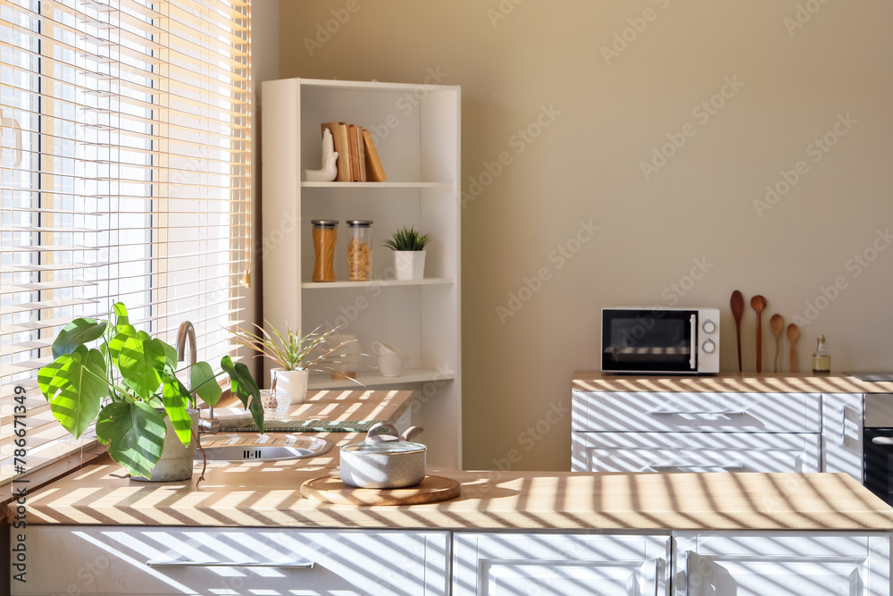 Interior of modern kitchen with wooden counters