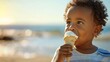 A smiling African American toddler boy child holds ice cream on a hot summer day on blurred beach. Ice cream in a waffle cone. A happy and contented child enjoy his sweet summer vacation, copy space.