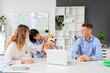 © Pixel-Shot - Business people petting Corgi dog at table in office