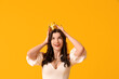© Pixel-Shot - Beautiful young woman in stylish prom dress and paper crown on yellow background