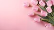 A Delicate Bouquet of Pink Tulips on a Soft Pink Background