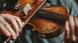Close-up of hands playing old violin with bow