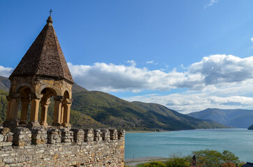 Wall Mural - Picturesque view to Ananuri Fortress Complex with turquoise waters of the Zhinvali Reservoir surrounded by mountains located on the Georgian Military Highway