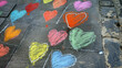 A city sidewalk with chalk drawings of hearts.