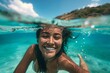Cheerful girl swimming underwater on a sunny day