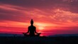 © Artyom - Silhouette of person meditating in lotus position at sunset with vibrant red sky