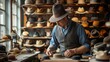 A hat maker shaping a felt hat on an old-fashioned hat block, surrounded by an array of finished hats on display.